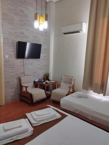 a hotel room with two beds and a tv at The English Guest House in Ruse
