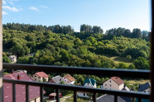 a view of a town on a hill with trees at Nanooq Apartments in Kolašin