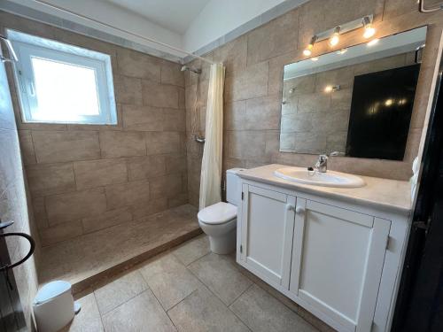 a bathroom with a sink and a toilet and a mirror at Sa TORRE 2 by SOM Menorca in Fornells