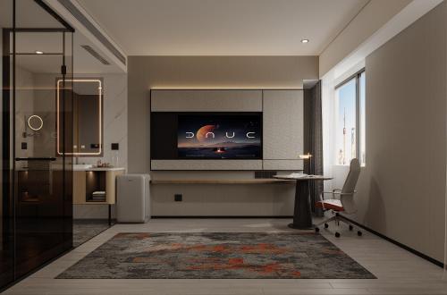 a living room with a flat screen tv on a wall at 枫渡酒店上海陆家嘴店 in Shanghai