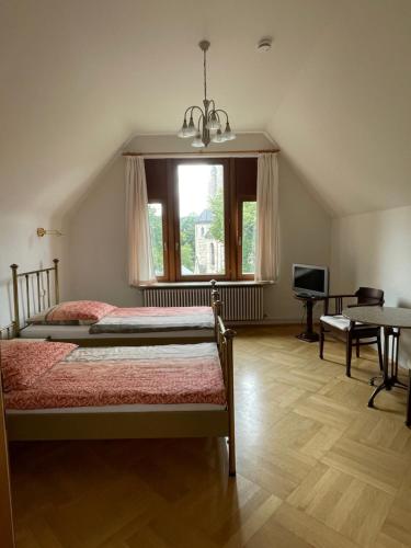 a bedroom with two beds and a window at Hotel Villa Tosca in Hannover
