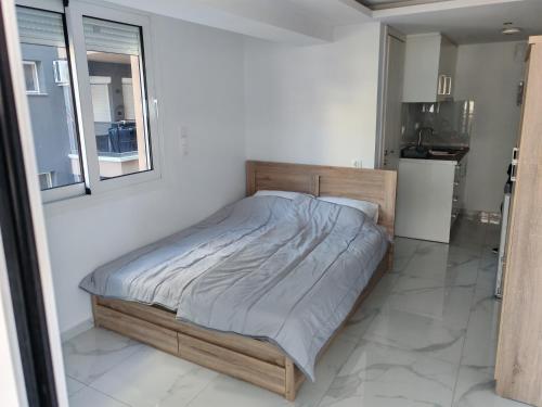 a bedroom with a bed in a white room at Premium Studio Family II in Paralia Katerinis