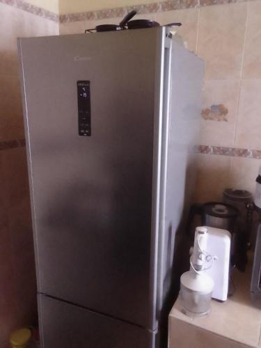 a stainless steel refrigerator in a kitchen next to a counter at دار السياحة in Larache