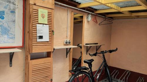 a bike is parked in a room with a wall at Hotel garni & Oma's Heuhotel 'Pension zur Galerie' in Barby