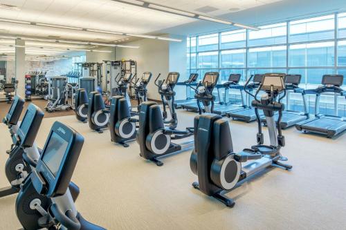 a gym with rows of treadmills and elliptical machines at The Westin Boston Seaport District in Boston