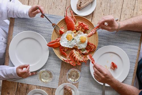 a group of people sitting at a table with breakfast food at Catalonia Royal Ses Estaques-Adults Only in Santa Eularia des Riu