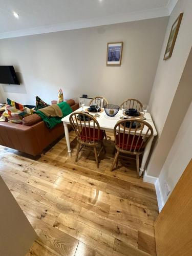 a living room with a table and chairs and a couch at Marina Flat, Swansea - Perfect Location in Swansea