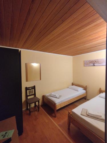 a bedroom with two beds and a wooden ceiling at The English Guest House in Ruse