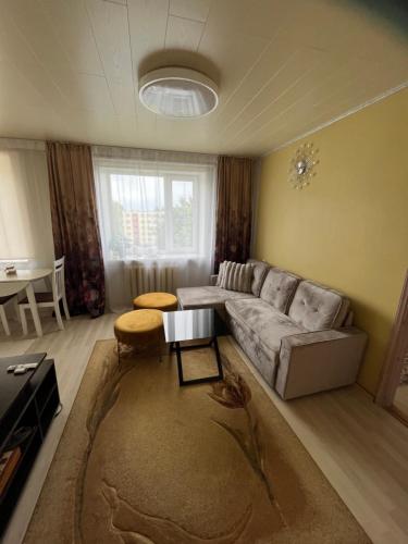 a living room with a couch and a table at Kaksio in Pärnu