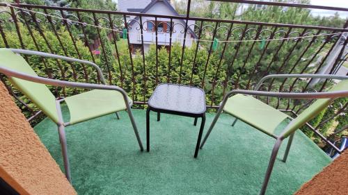 a couple of chairs sitting on a balcony at Rafa in Trzęsacz