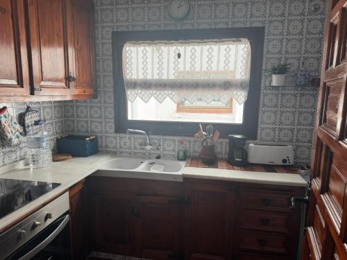 a kitchen with a sink and a window at Sea breeze in Vilanova i la Geltrú