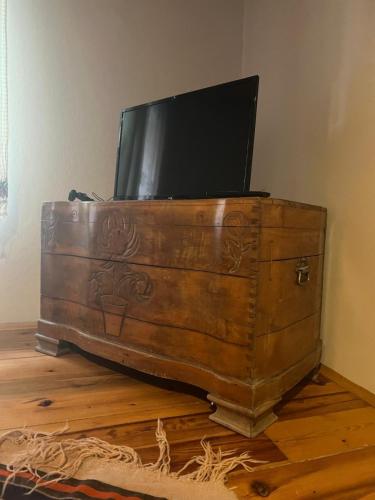 a wooden chest with a tv on top of it at şekercigiller in Ayvalık
