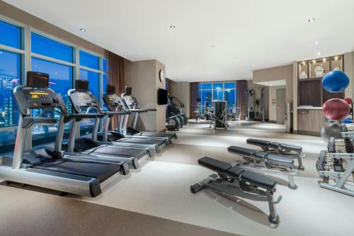 a gym with treadmills and elliptical machines at AC Hotel by Marriott Charlotte City Center in Charlotte