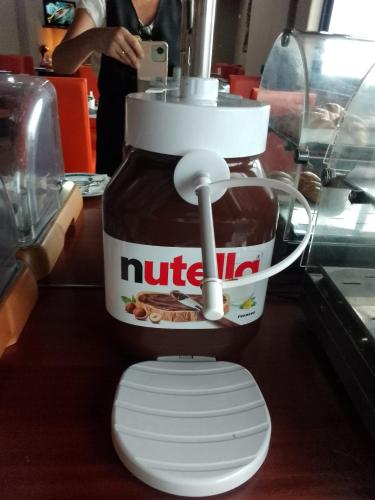 a jar of nutella sitting on top of a toilet at Hotel La Fayette Giugliano Licola in Giugliano in Campania