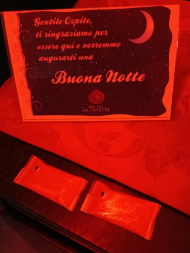 a box of orange lipstick with a sign on it at Hotel La Fayette Giugliano Licola in Giugliano in Campania