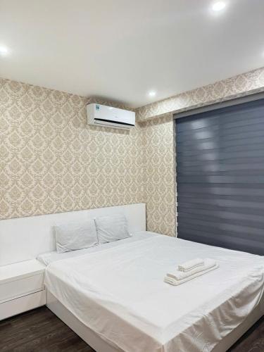 Ένα ή περισσότερα κρεβάτια σε δωμάτιο στο Bai Chay Apartment