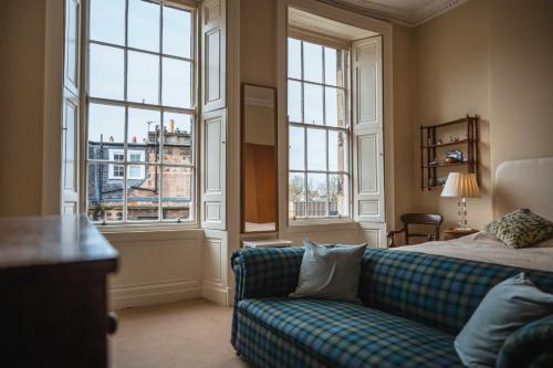 a living room with a couch and large windows at 19-4 Union Street in Edinburgh