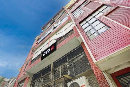 a red building with a sign on it at Super Hotel O Green Park Residency in New Delhi