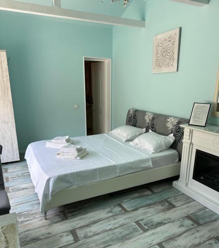 a blue bedroom with a bed and a fireplace at Solaria House in Constanţa