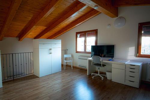 an office with a desk and a computer in a room at Loft in Bagnara di Romagna