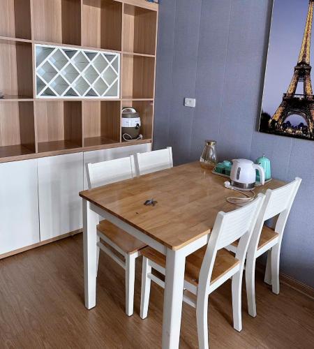 a kitchen with a wooden table and chairs and the eiffel tower at Homestay Hạ Long NewLife in Kon Rung (1)