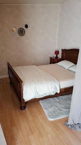 a bedroom with a bed and a fan on the wall at Studio meublé in Le Mans