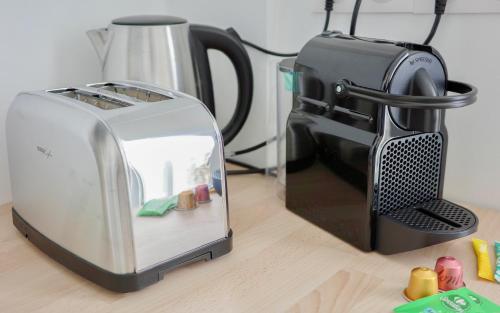 a toaster sitting next to a toaster on a table at Le City Chic in Compiègne