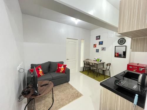 a living room with a couch and a table at RCL Homestay condo unit in Mactan Island