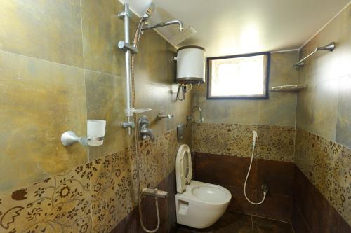 a bathroom with a toilet and a shower at SBHS Homestay - Neeladri - Mangalam Road in Tirupati