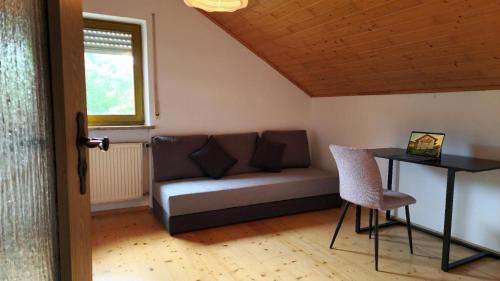 a living room with a couch and a table at Bachoase Bischofsmais in Bischofsmais
