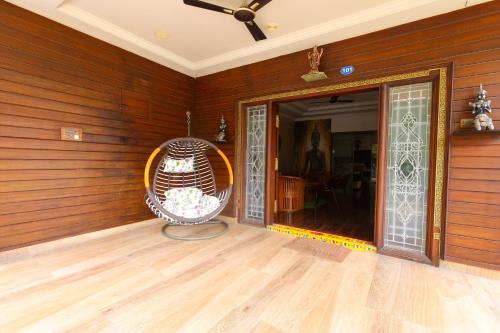 a room with a chair in the corner of a room at SBHS Homestay - Neeladri - Mangalam Road in Tirupati