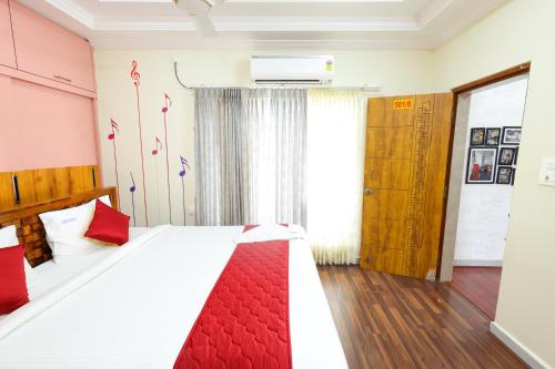a bedroom with a large bed with a red blanket at SBHS Homestay - Neeladri - Mangalam Road in Tirupati