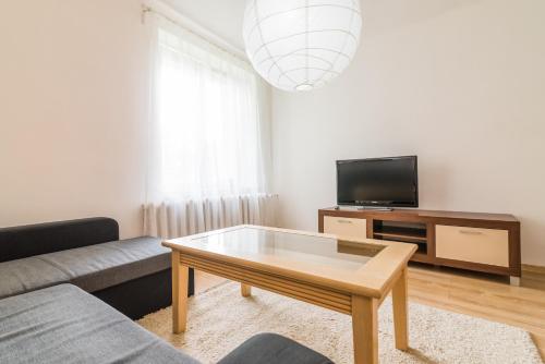 a living room with a couch and a coffee table at Apartament Ku Słońcu - Hel in Hel