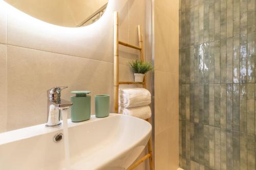 a bathroom with a sink and a mirror and a shower at mari DAMARI in Riposto