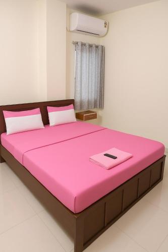 a large pink bed in a room at Hotel Bankebihari Regency in Pune