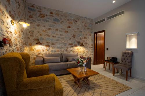 a living room with a couch and a table at Anemos Suites Mani 