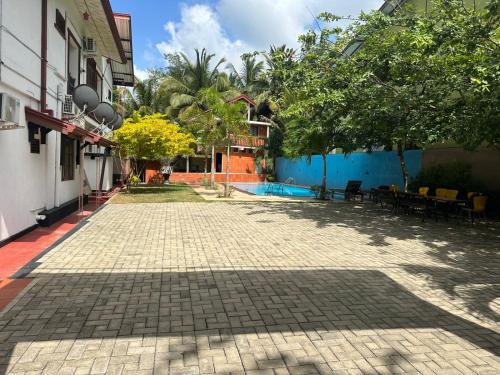 a cobblestone street in a courtyard of a building at Difference Rajarata Hotel in Anuradhapura