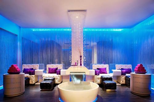 a room with a table and chairs and a large column at W Bali - Seminyak in Seminyak