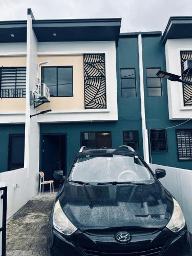 a car parked in front of a house at Melt & Laze Cozy Stylish Aesthetic Relaxing House in San Pablo
