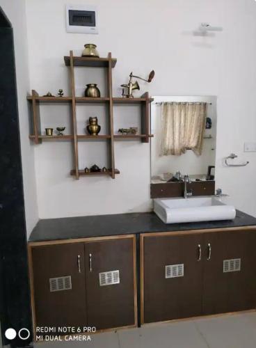 a bathroom with a sink and a counter at Holé's FarmVille in Mulshi