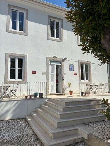 a white building with stairs in front of it at Sintra Flower Vintage Chalet in Sintra