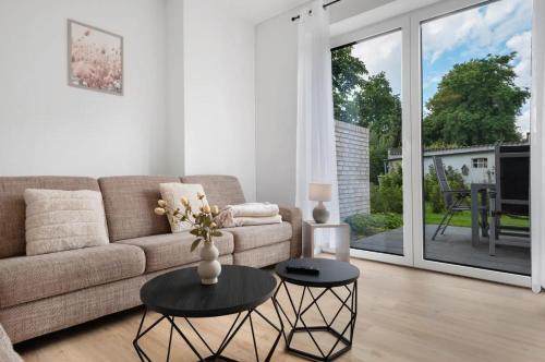 a living room with a couch and a table at Das Strandhaus 2, mit Garten, 250 Meter zum See in Lembruch