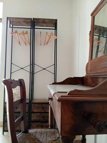 a room with a piano and a chair next to a table at La Casa del Ghiro in Brirus