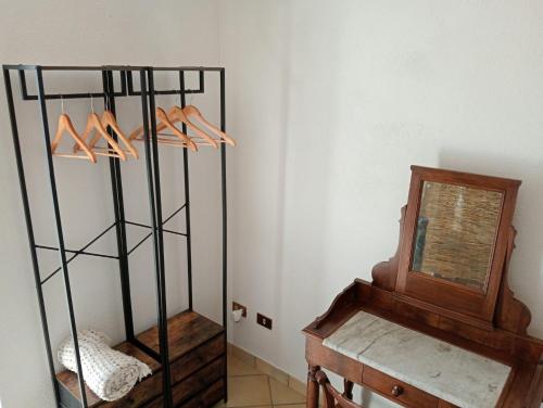 a room with a table and a shelf with shoes at La Casa del Ghiro in Brirus