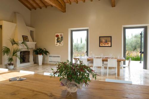 a living room with a table and a fireplace at Agriturismo Tra gli Ulivi, Chiappini Winery in Bolgheri