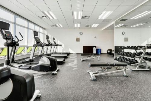 a gym with rows of treadmills and machines at SpringHill Suites by Marriott Dallas Mansfield in Mansfield