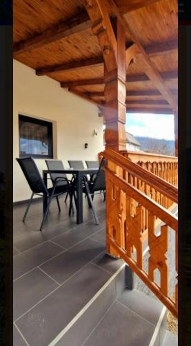 a view from the balcony of a house with a table and chairs at Casa Edy in Vişeu de Sus
