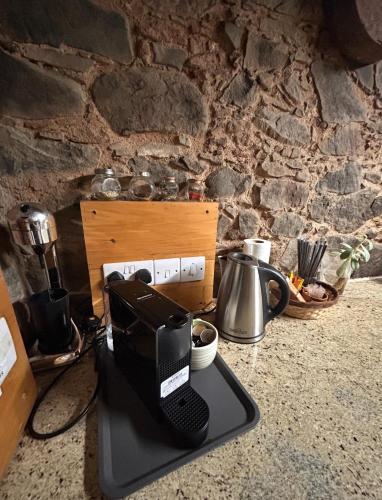 a coffee maker sitting on top of a counter at Lasmari's Bouquet in Sykopetra