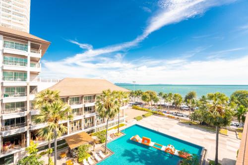 an aerial view of the resort with a swimming pool and the ocean at Welcome World Beachfront Resort in Pattaya South