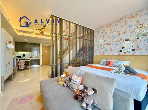 a bedroom with a bed and a couch with stuffed animals at Alviv 99 Suites I Family Suite I 4-7 pax I 5minsMelakaCruise I JonkerSt in Melaka